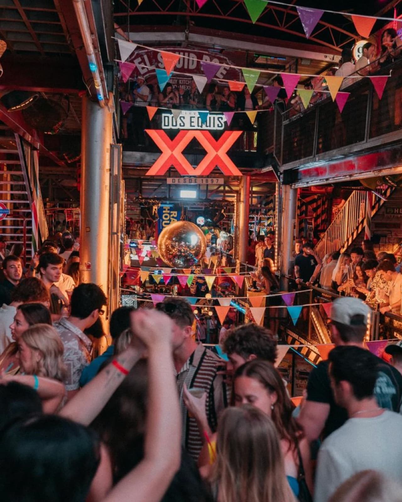 Disco ball glowing over a huge crowd during a live show at El Squid Roe in Cabo San Lucas