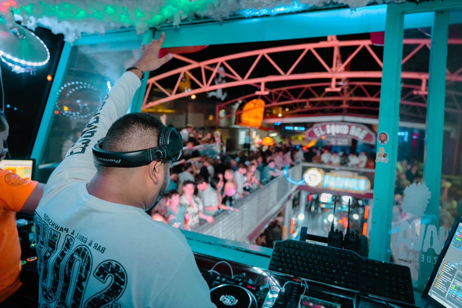 DJ booth firing up the crowd during an event night at El Squid Roe Cabo San Lucas